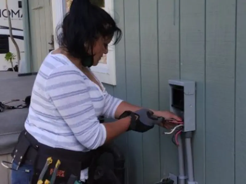 Licensed electrician wiring an exterior subpanel in Offutt AFB