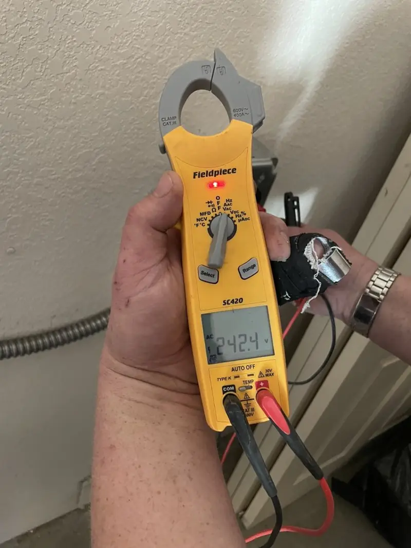 Voltage testing with clamp meter during Ceiling Fan Installation in Offutt AFB